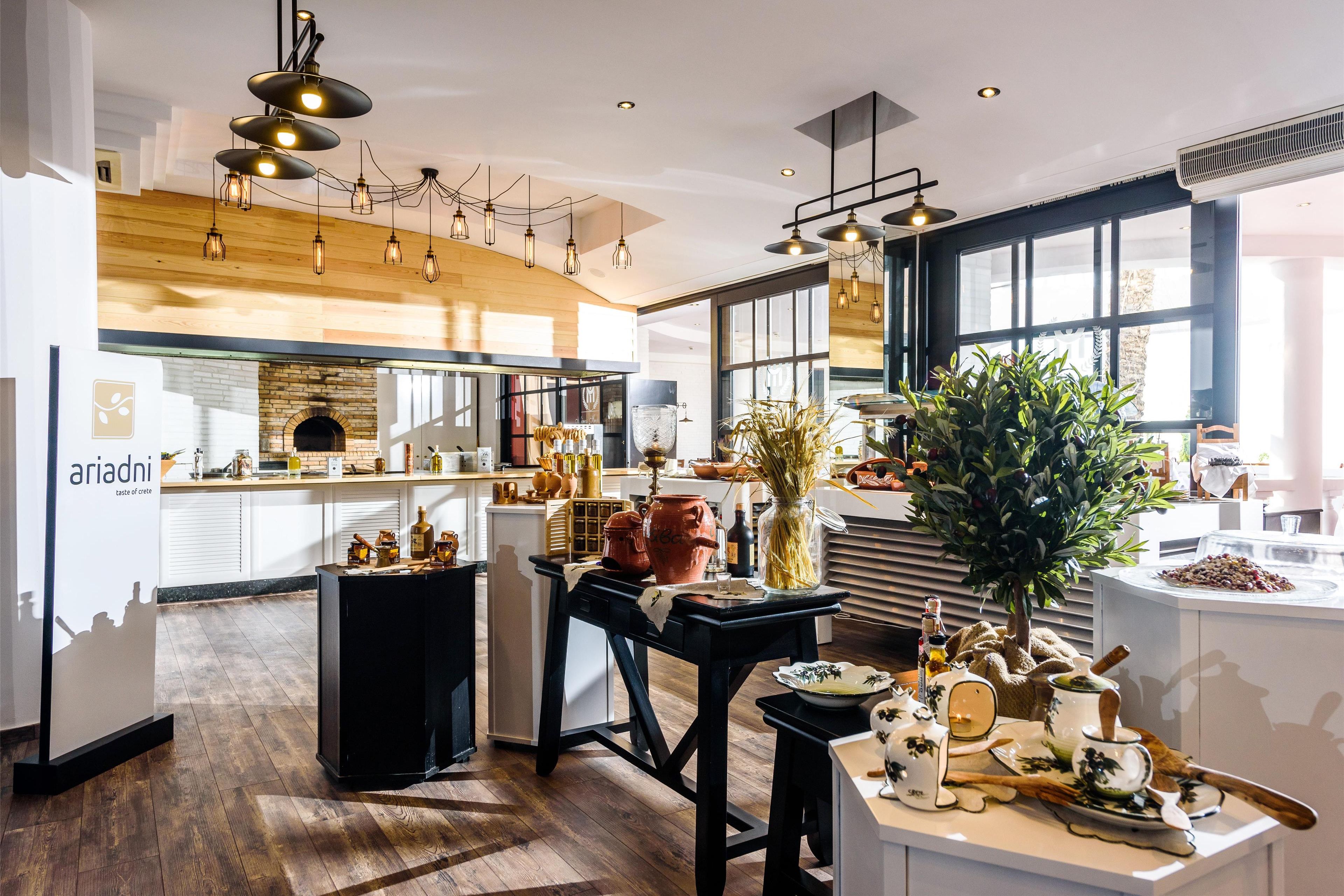 A modern kitchen with wooden accents, a black dining table, and a large window.