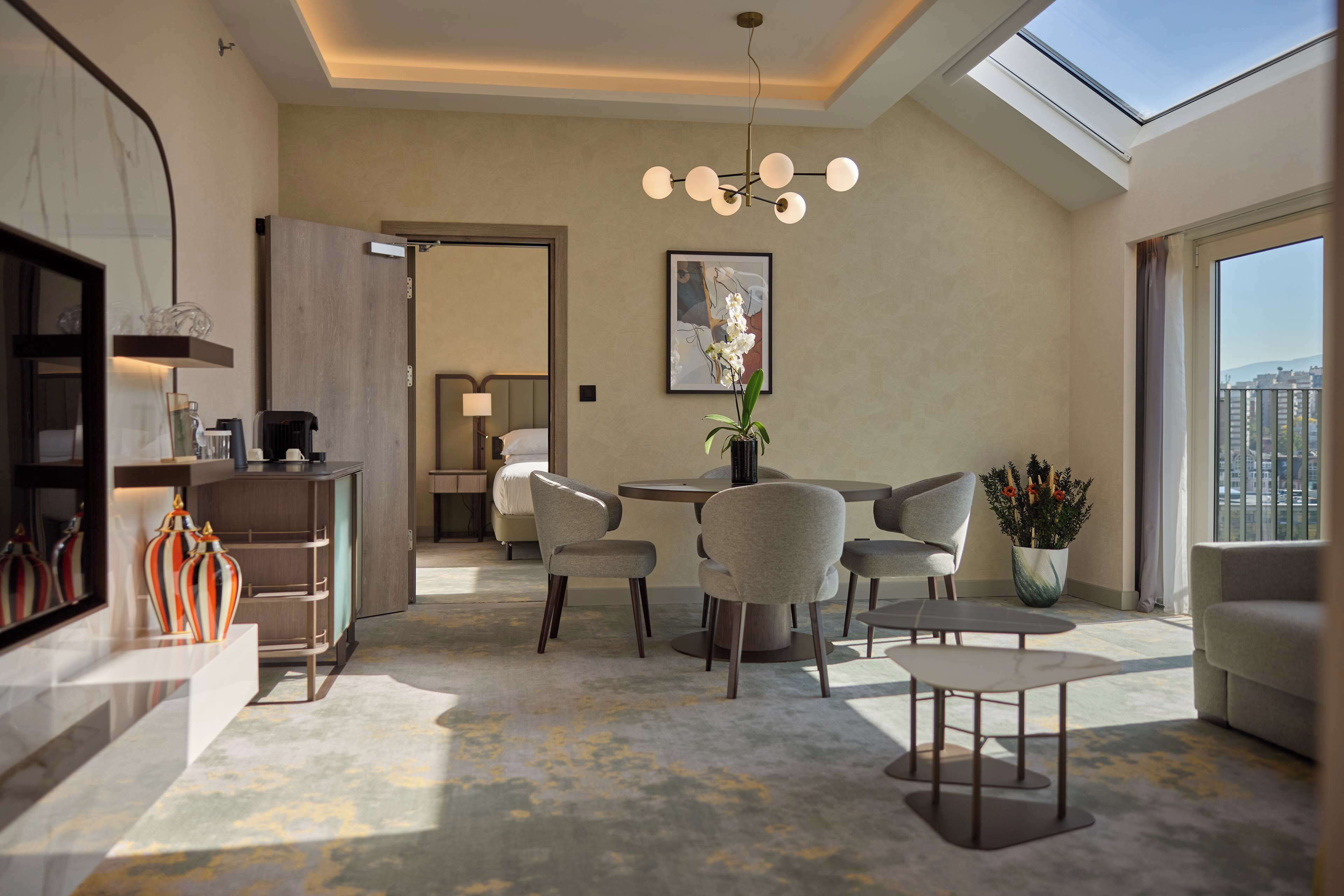 A modern living room with a skylight, a dining area, and a view of the city.