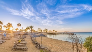 On the beach, sun loungers, beach umbrellas, beach towels