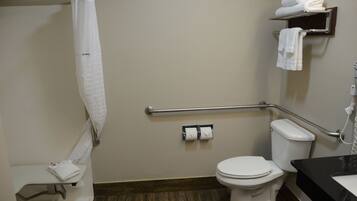 A bathroom with a shower, toilet, and a sink.