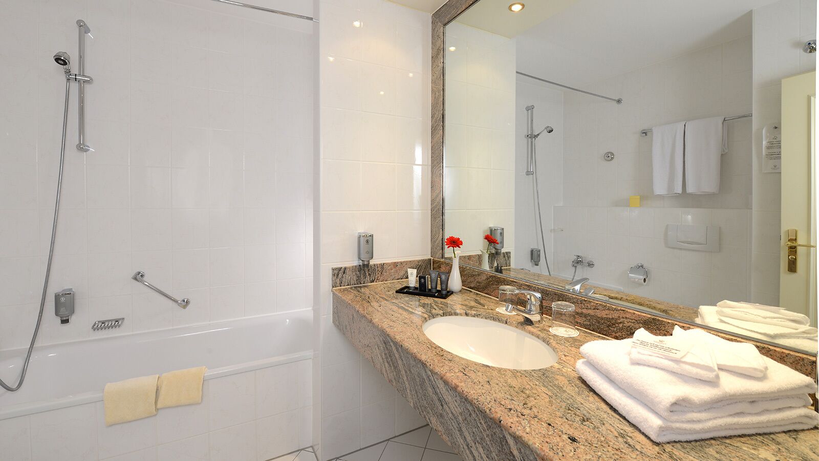 bathtub, hair dryer, towels, soap