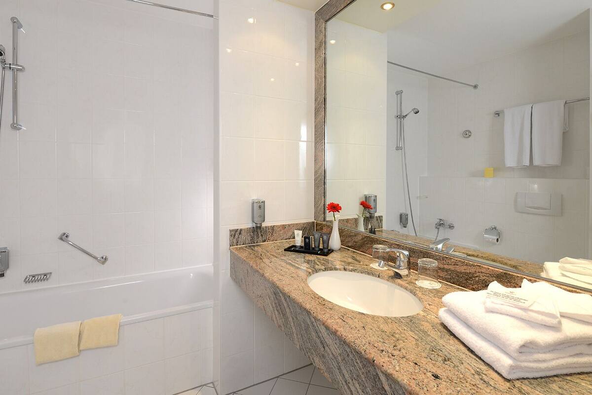 bathtub, hair dryer, towels, soap