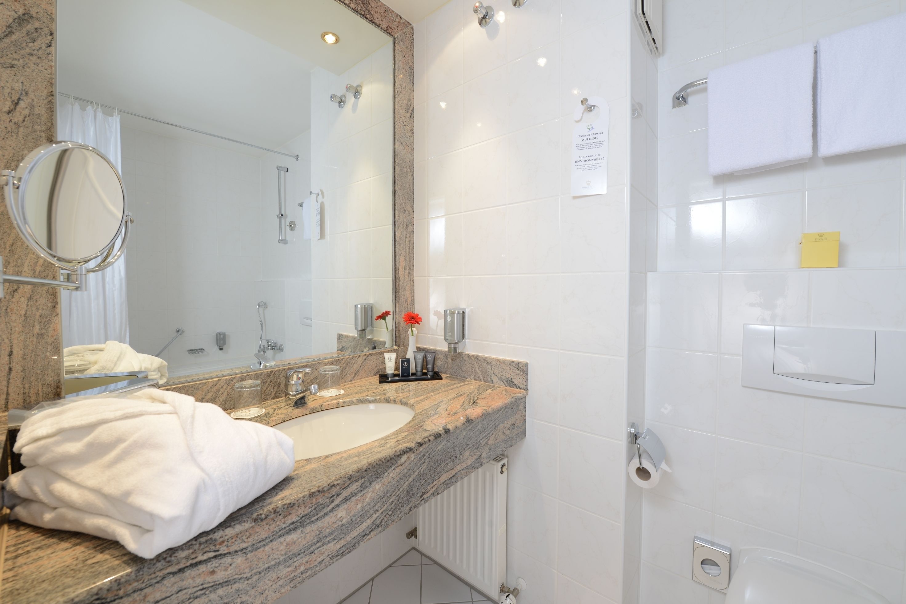 bathtub, hair dryer, towels, soap