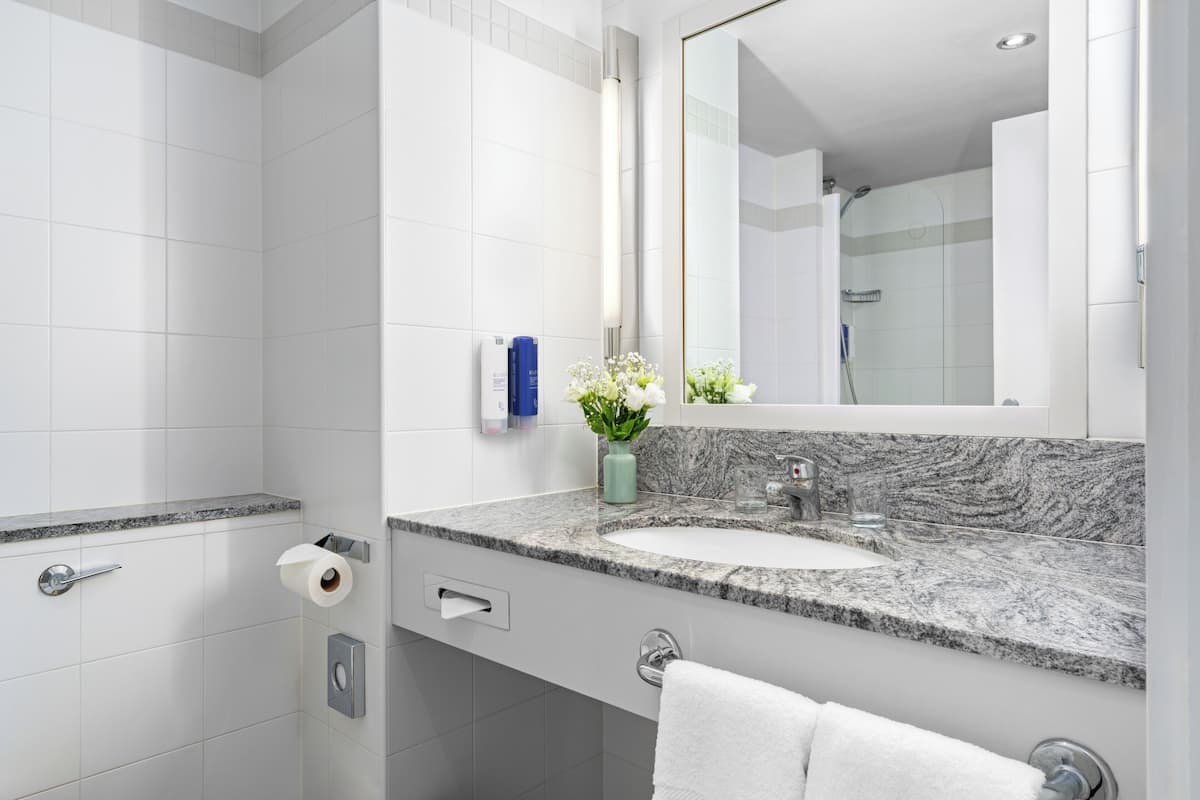 combined shower/bathtub, designer toiletries, hair dryer, slippers