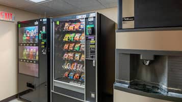 A vending machine with a variety of snacks and a water dispenser.