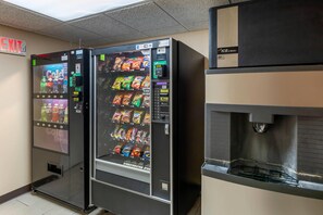 A vending machine with a variety of snacks and a water dispenser.