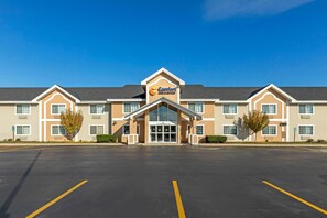 A Comfort Suites hotel with a central entrance, multiple windows, and a parking lot.