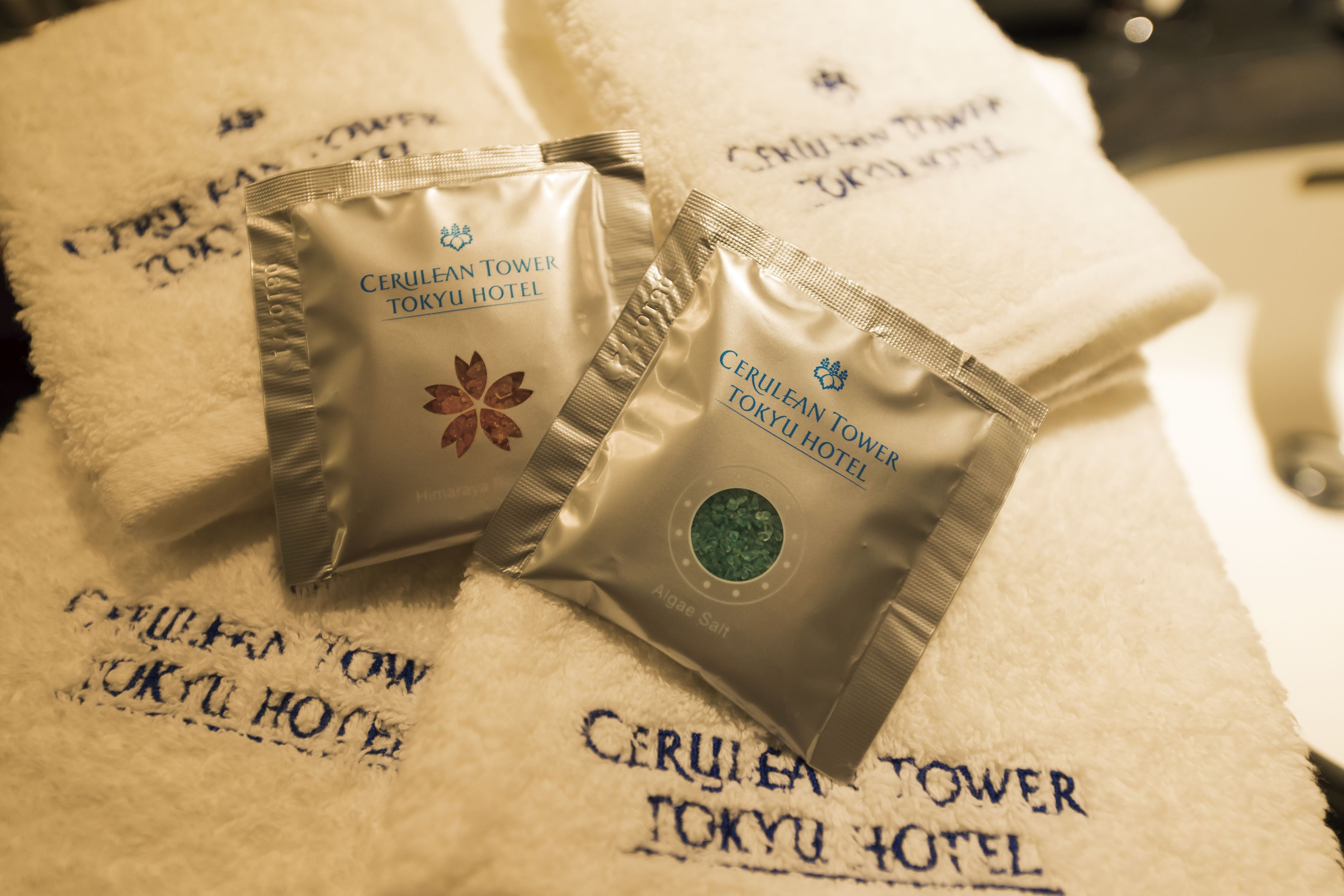 designer toiletries, hair dryer, bathrobes, slippers