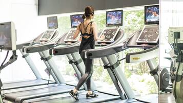 A treadmill with a digital display and a person walking on it.