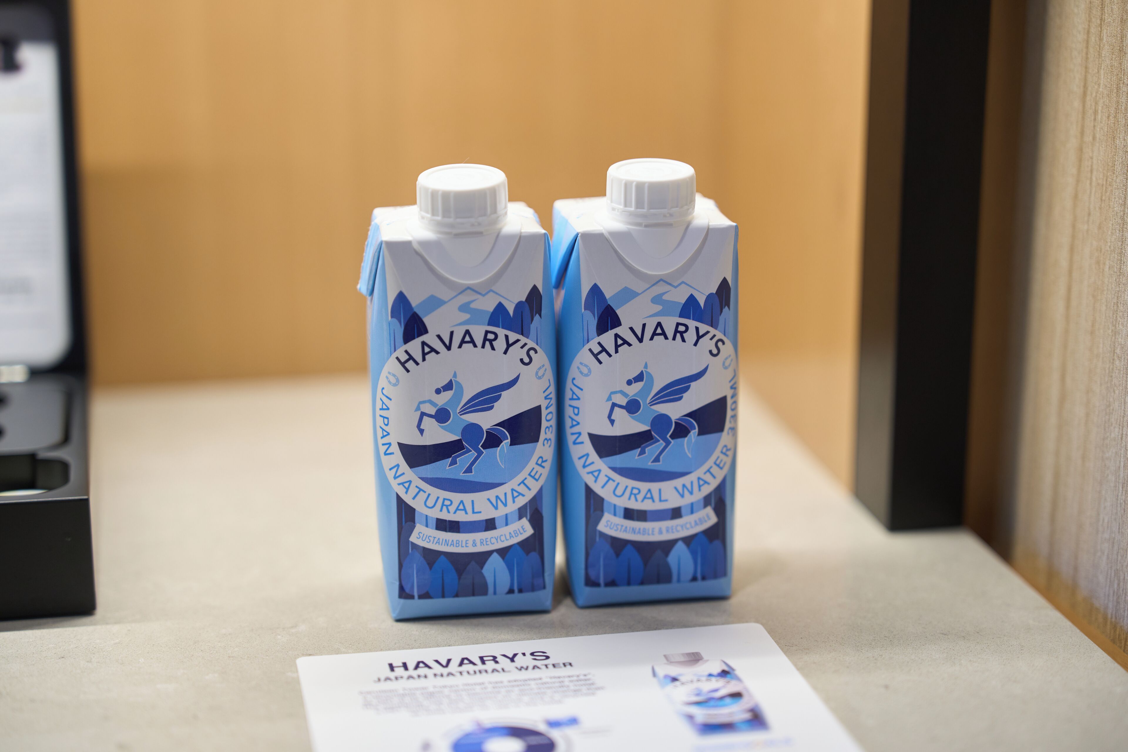 Two cartons of Havary's Natural Water on a counter with a brochure.
