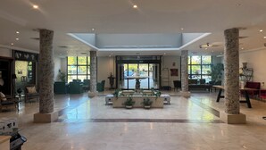 A spacious lobby with marble columns, a central fountain, and seating areas. - Hotel Segovia Sierra de Guadarrama (El Espinar)