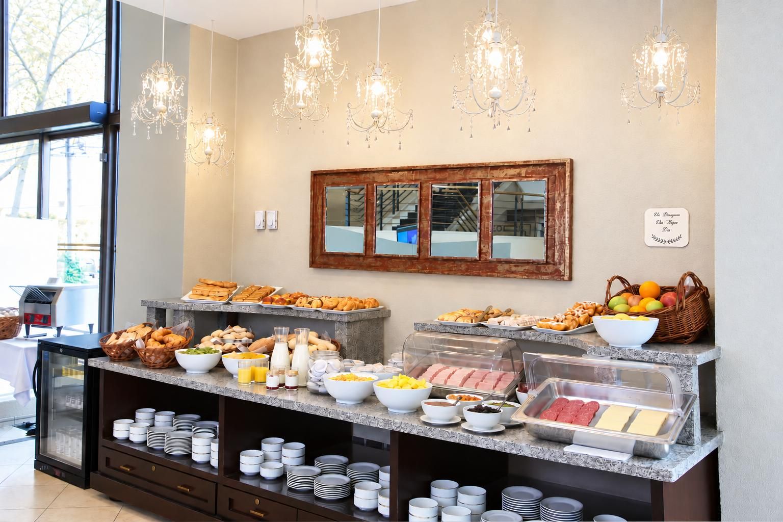 A buffet setup with various food items and a mirror above it.