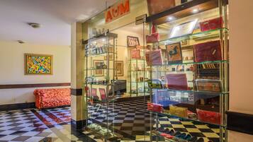 A boutique store with glass display cases and a checkered floor.