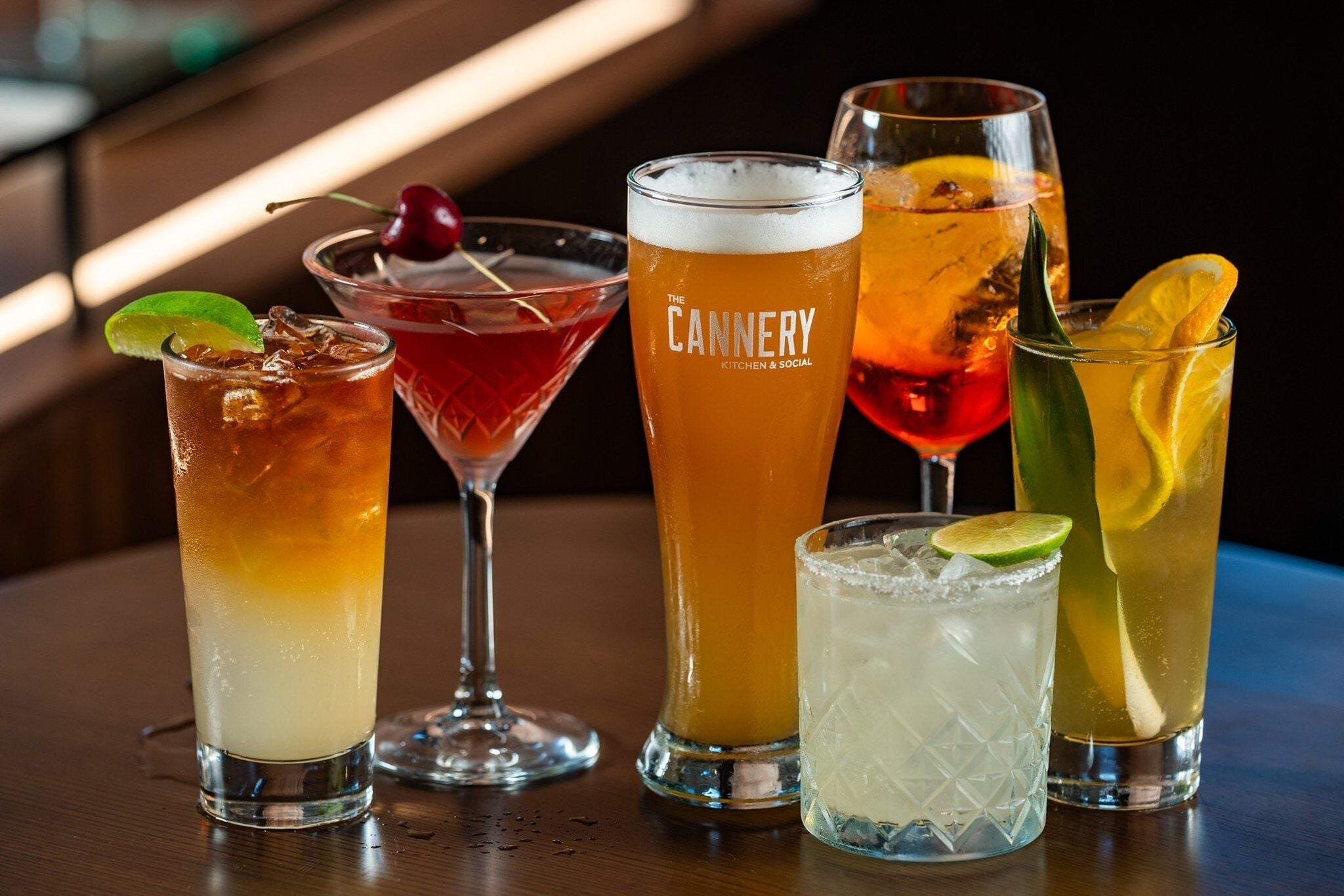 A variety of drinks on a bar table.