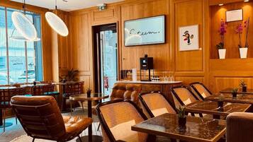 A modern interior with wooden paneling, leather seating, and a bar area.
