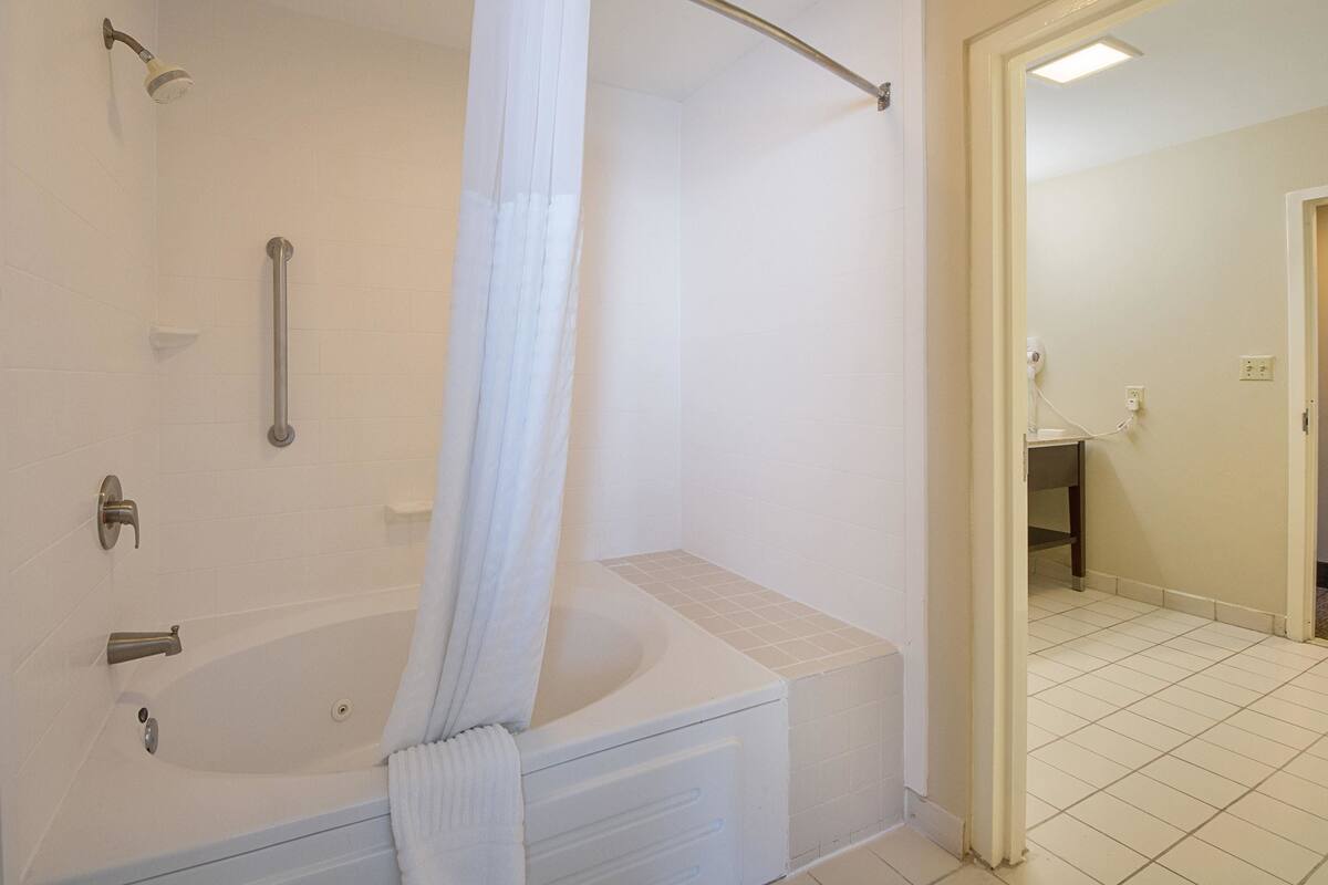 A bathroom with a bathtub, a shower, and a toilet.