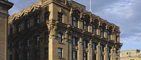 A historic building with ornate architectural details and multiple windows.