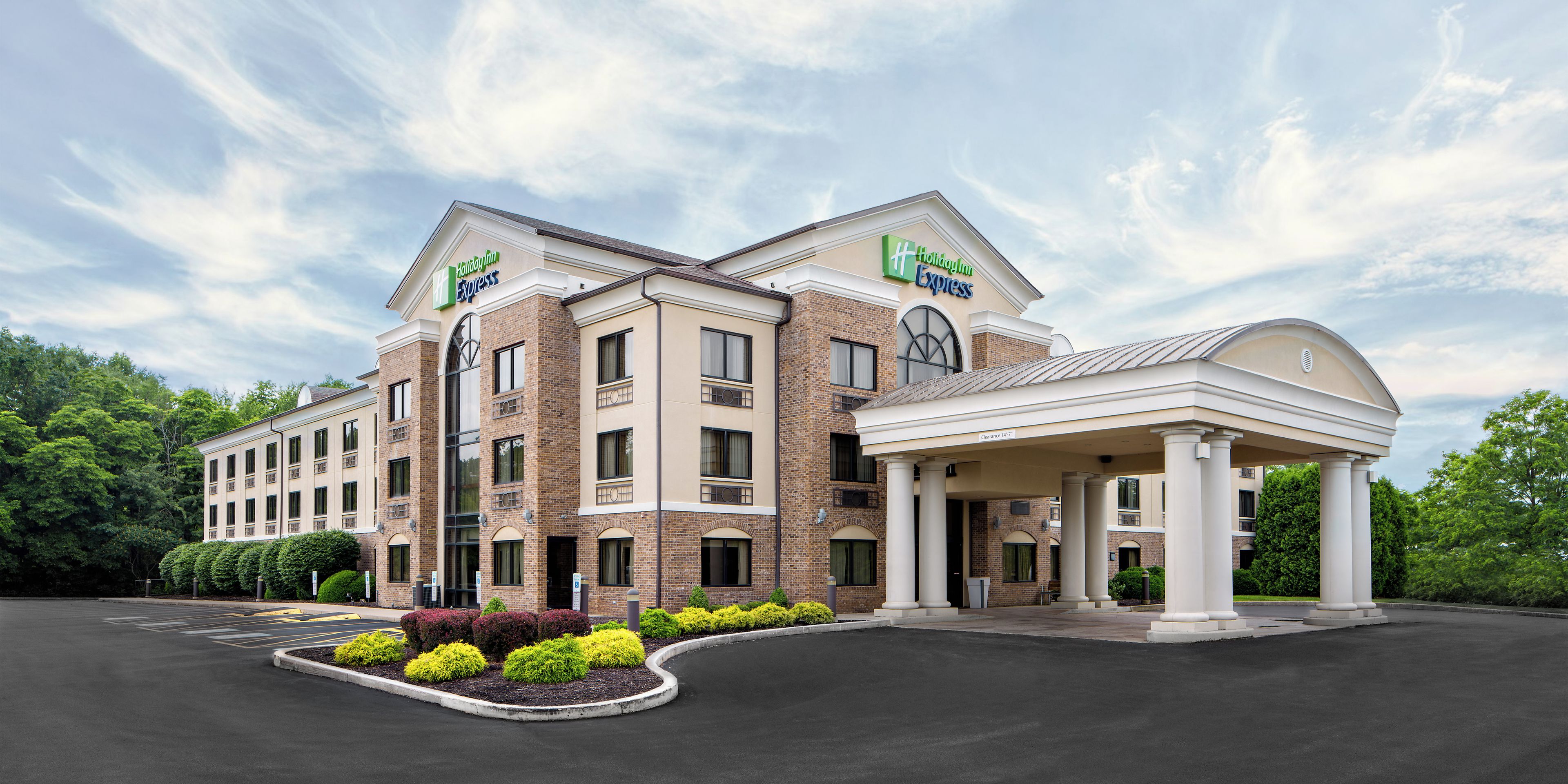 A Holiday Inn Express hotel with a covered entrance and a landscaped front yard.
