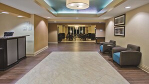 A hotel lobby with a reception desk, seating area, and a large chandelier. - La Quinta Inn & Suites by Wyndham Hot Springs (Hot Springs)