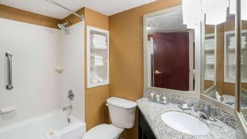 A bathroom with a bathtub, toilet, and sink.