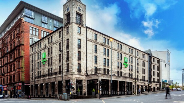 A historic building with a clock tower, large windows, and a prominent entrance. - Holiday Inn Glasgow City Theatreland by IHG (Glasgow)