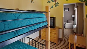 A room with a bunk bed, a wooden dresser, a television, and a mirror. - Holiday Inn Express & Suites Byron by IHG (Byron)