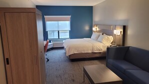 A hotel room with a bed, a sofa, a desk, and a wardrobe. - Holiday Inn Express Hotel & Suites Plymouth by IHG (Plymouth)