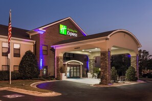 A Holiday Inn Express hotel with a brick facade, a covered entrance, and a flagpole. - Holiday Inn Express Plymouth by IHG (Plymouth)
