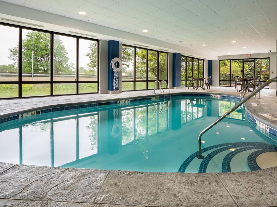 Ein hallenbad mit klarem Wasser, einem Rettungsring und einer Poolleiter.