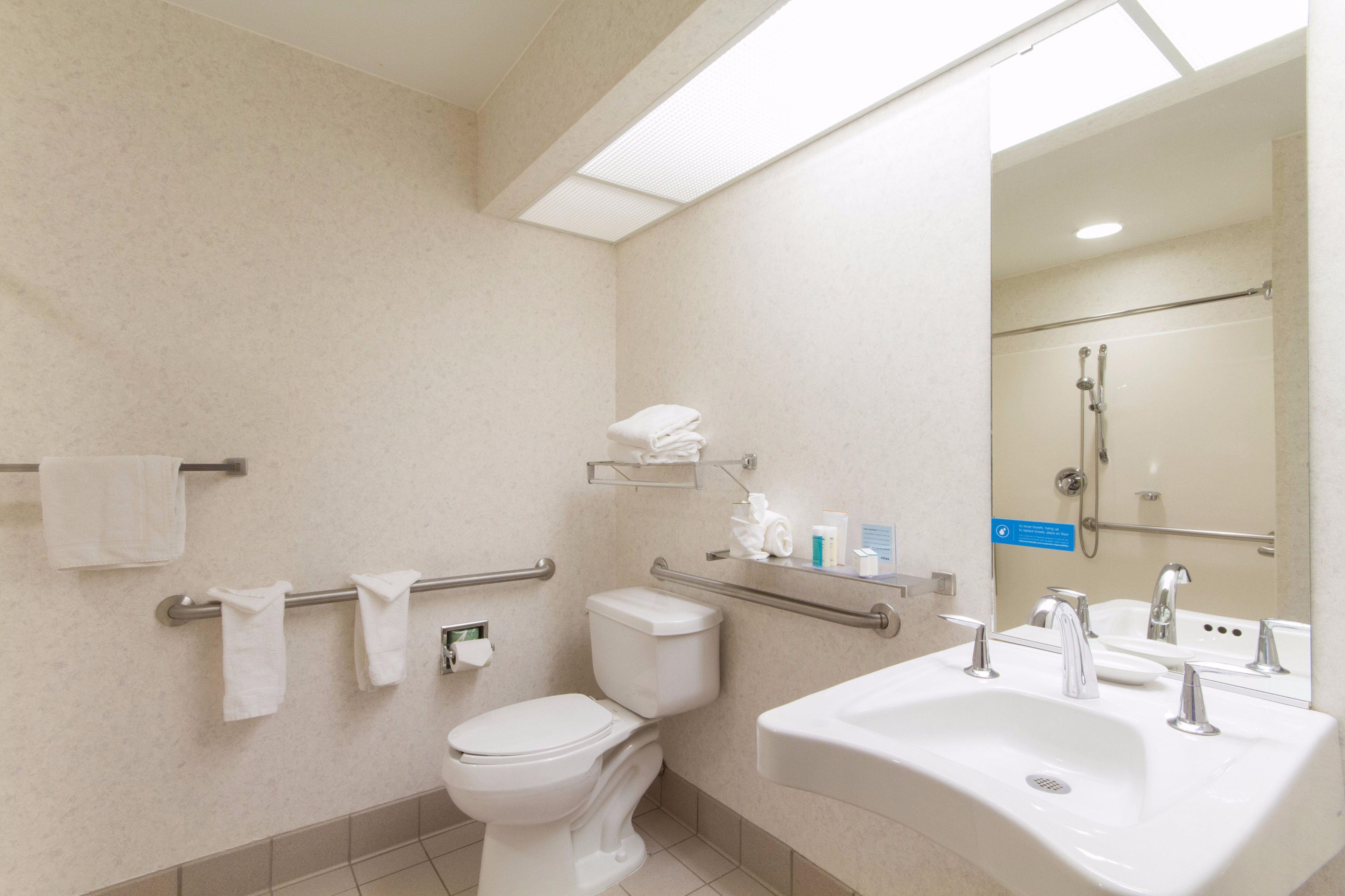 A bathroom with a toilet, sink, and shower.