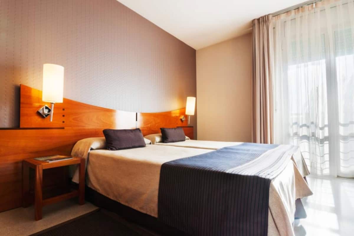 twin room | minibar, in-room safe, desk, blackout curtains