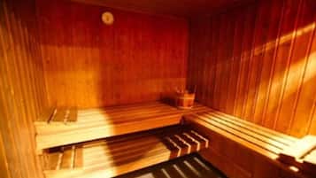 A sauna with wooden benches and a small bucket.