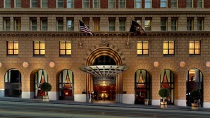 A hotel with a classic facade, large arched windows, and a prominent entrance with a canopy. - Omni San Francisco Hotel (San Francisco)