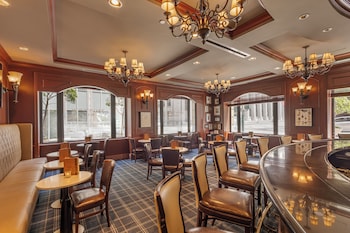 A hotel with a classic facade, large arched windows, and a prominent entrance with a canopy. at Omni San Francisco Hotel