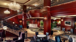 A grand lobby with a marble floor, a grand staircase, and a chandelier. - Omni San Francisco Hotel (San Francisco)