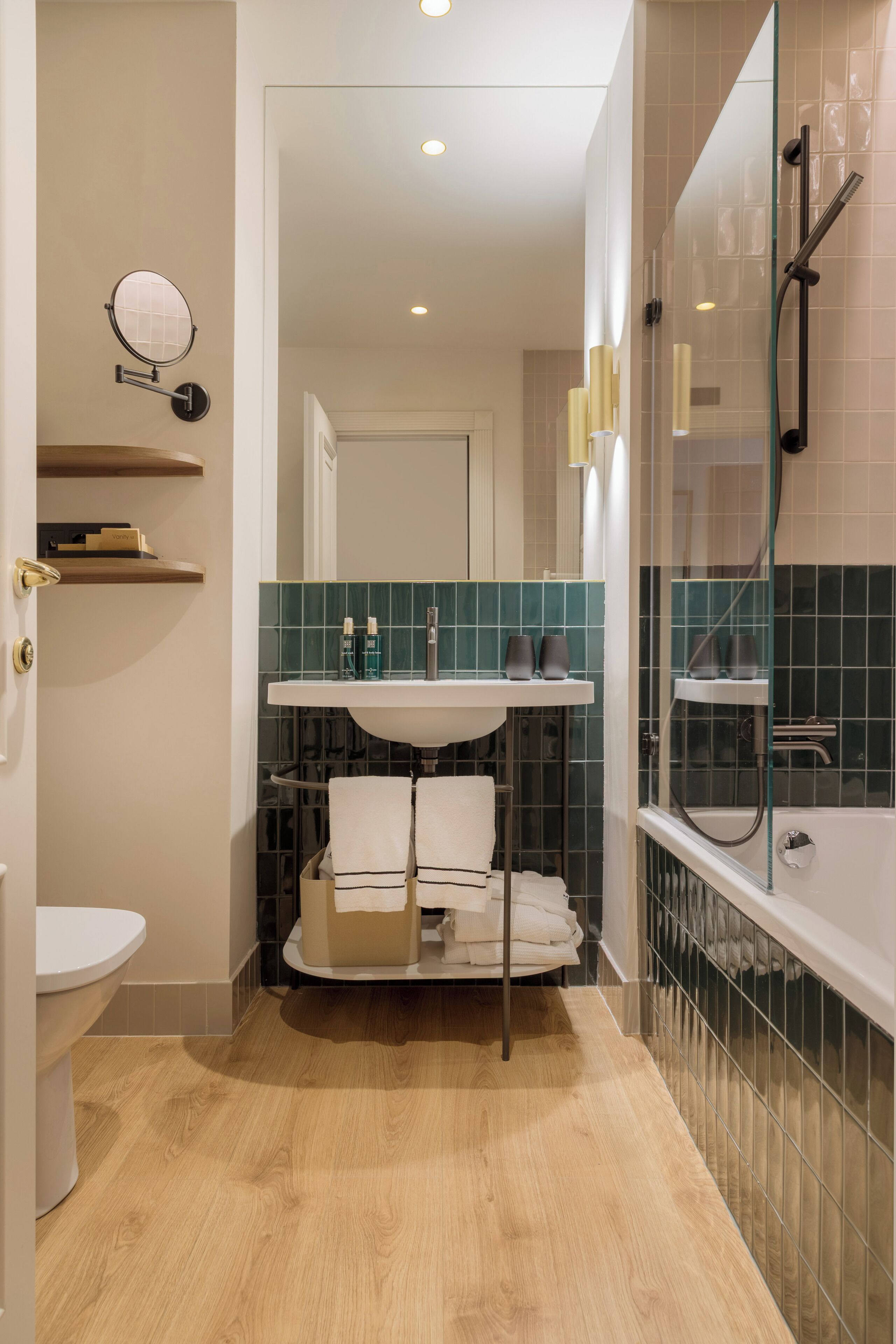 A modern bathroom with a toilet, sink, and shower area.