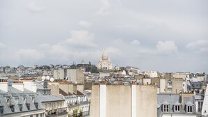 A cityscape with a prominent domed building in the distance, surrounded by various buildings and rooftops.