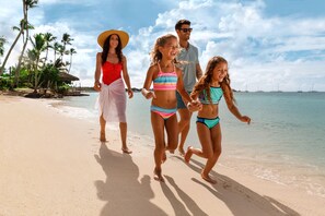 On the beach, white sand, beach cabanas, beach umbrellas
