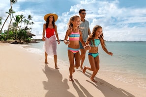 On the beach, white sand, beach cabanas, beach umbrellas