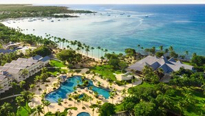 Een resort met meerdere zwembaden, een strand en uitzicht op de oceaan.