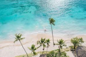 On the beach, white sand, beach cabanas, beach umbrellas