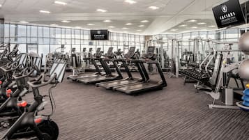 A gym with treadmills, stationary bikes, and weight machines.