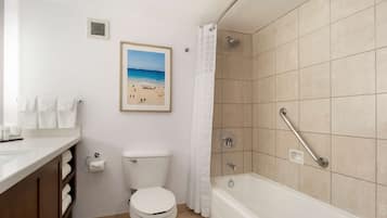 A bathroom with a toilet, sink, and bathtub.