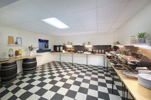 A checkered floor, a buffet setup, and a counter with various food items. - Swiss-Belresort Coronet Peak (Arthur's Point)