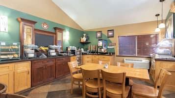 Enjoy meals at this classic restaurant with a central dining table and modern kitchen.