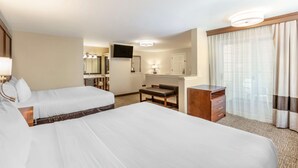 A hotel room with two beds, a desk, a chair, a dresser, a mirror, and a television. - Comfort Suites Red Bluff near I-5 (Red Bluff)