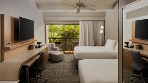 A hotel room with a desk, two beds, a TV, a ceiling fan, and a balcony with curtains. - Courtyard by Marriott Key West Waterfront (Key West)