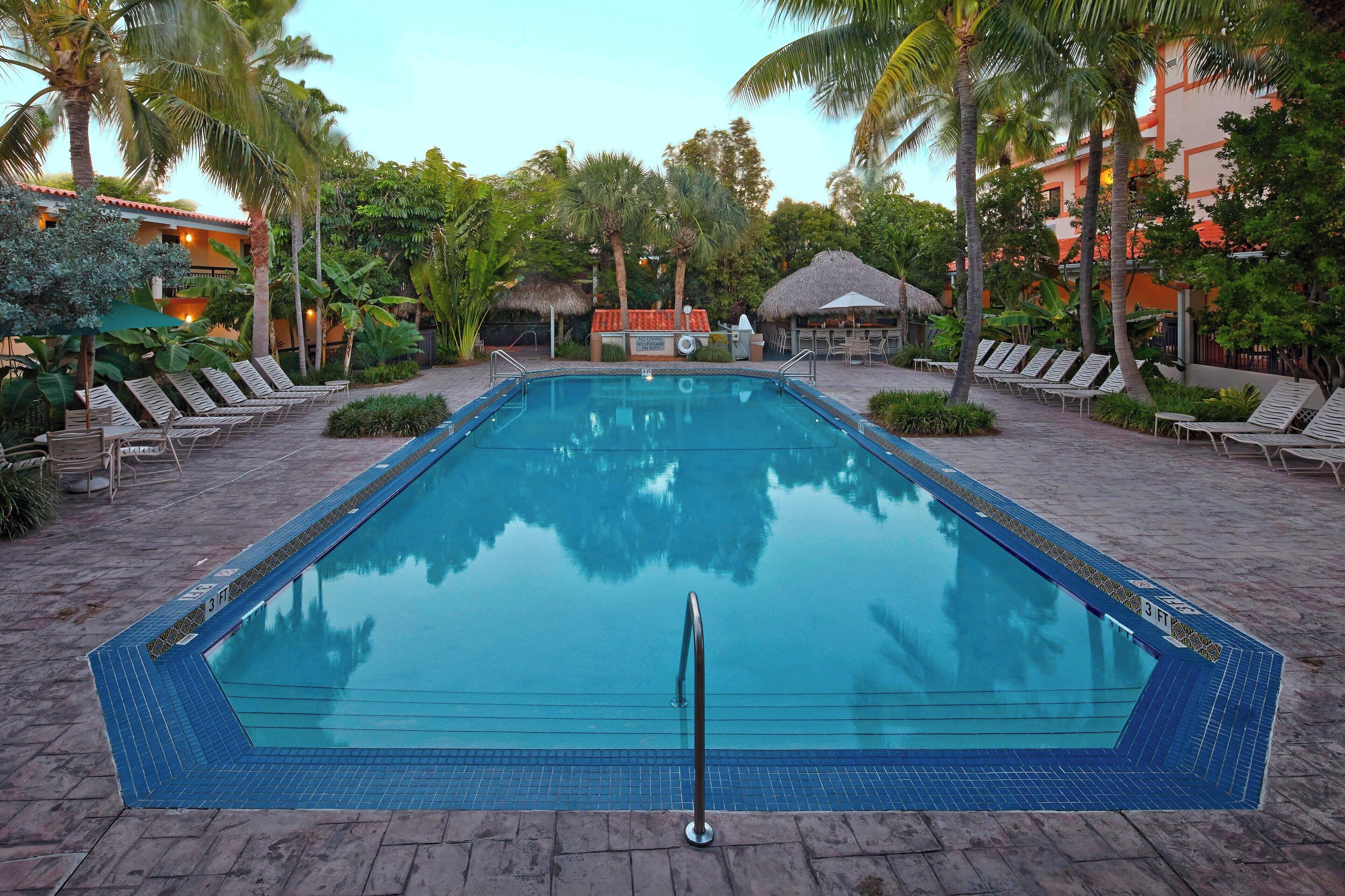 outdoor pool, open 6:00 am to 11:00 pm, pool umbrellas, pool loungers