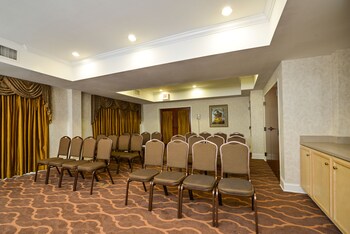 A gym with exercise equipment, a clock, and motivational artwork on the walls. at Comfort Suites Myrtle Beach Central
