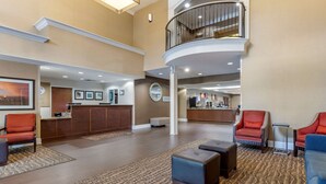 A spacious lobby with a reception desk, seating area, and a balcony. - Comfort Suites Myrtle Beach Central (Myrtle Beach)
